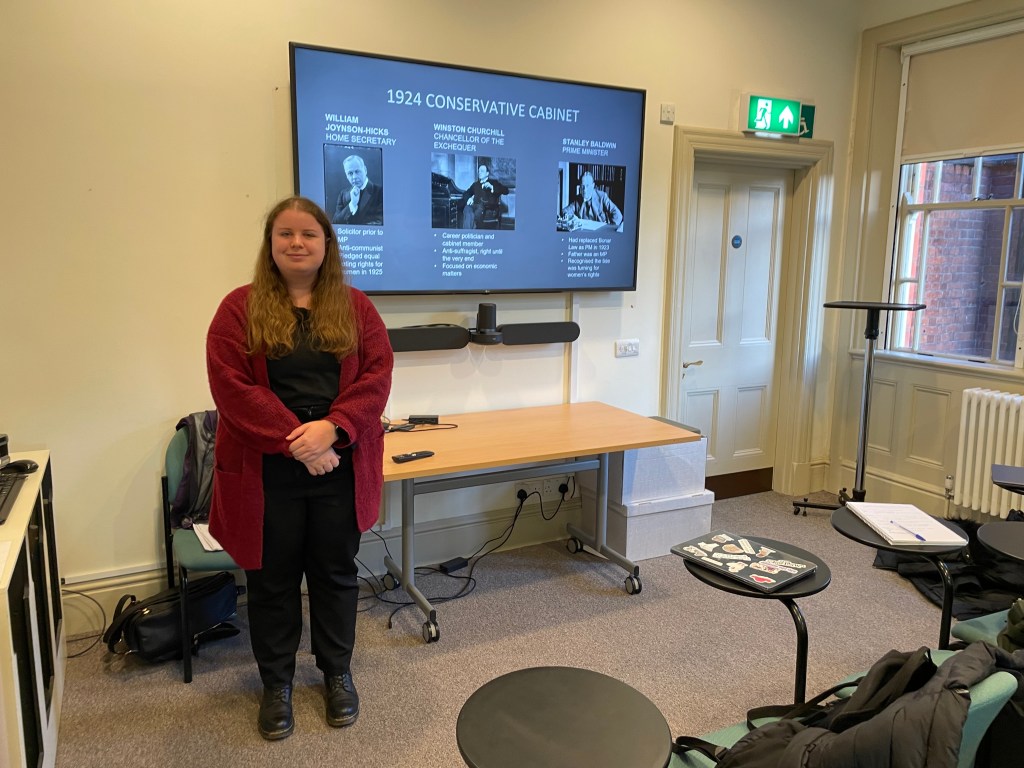 a student stood in front of a large screen